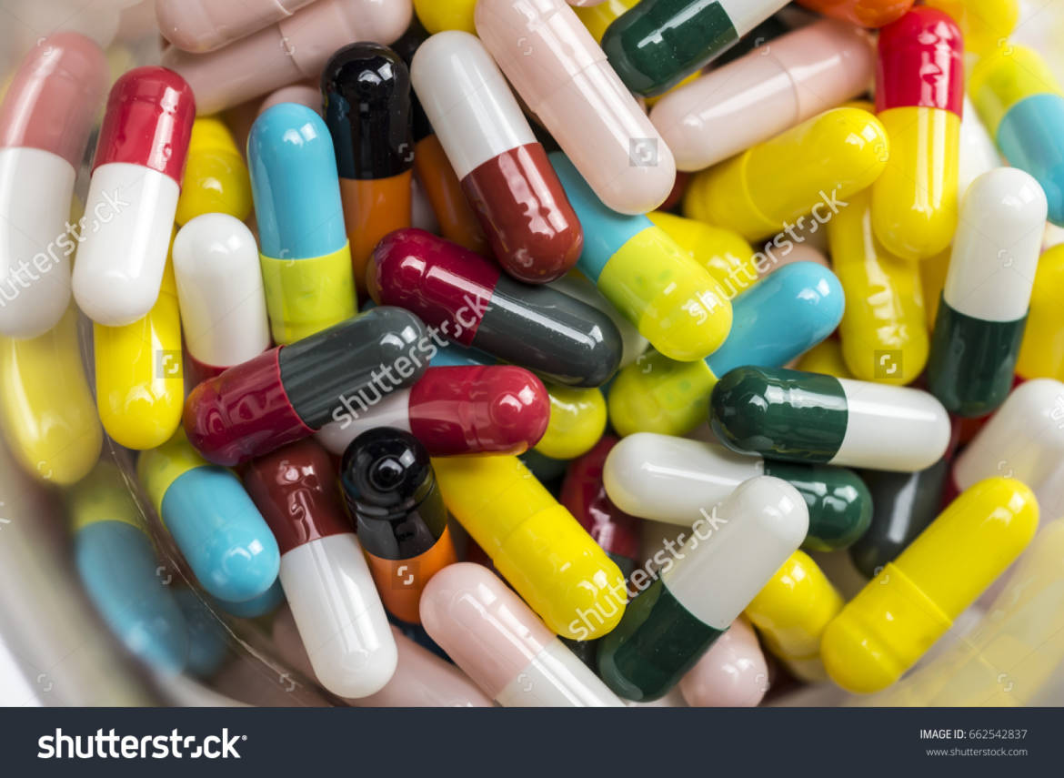stock-photo-close-up-shpt-of-colorful-pills-in-chemistry-beaker-662542837.jpg
