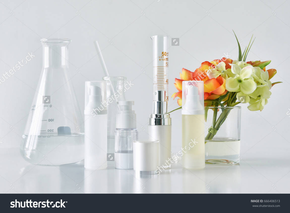 stock-photo-cosmetic-bottle-containers-with-green-herbal-leaves-and-scientific-glassware-blank-label-package-666406513.jpg