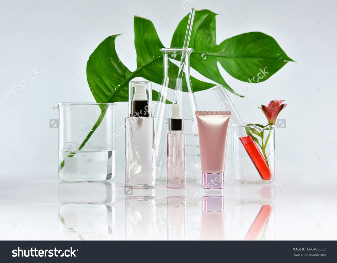 stock-photo-cosmetic-bottle-containers-with-green-herbal-leaves-and-scientific-glassware-blank-label-package-666406558.jpg