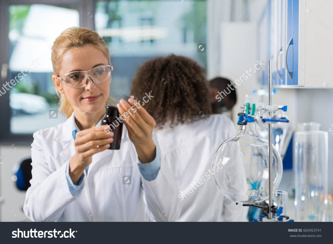 stock-photo-female-scientific-researcher-in-laboratory-doing-research-woman-working-with-chemicals-over-group-665953741.jpg