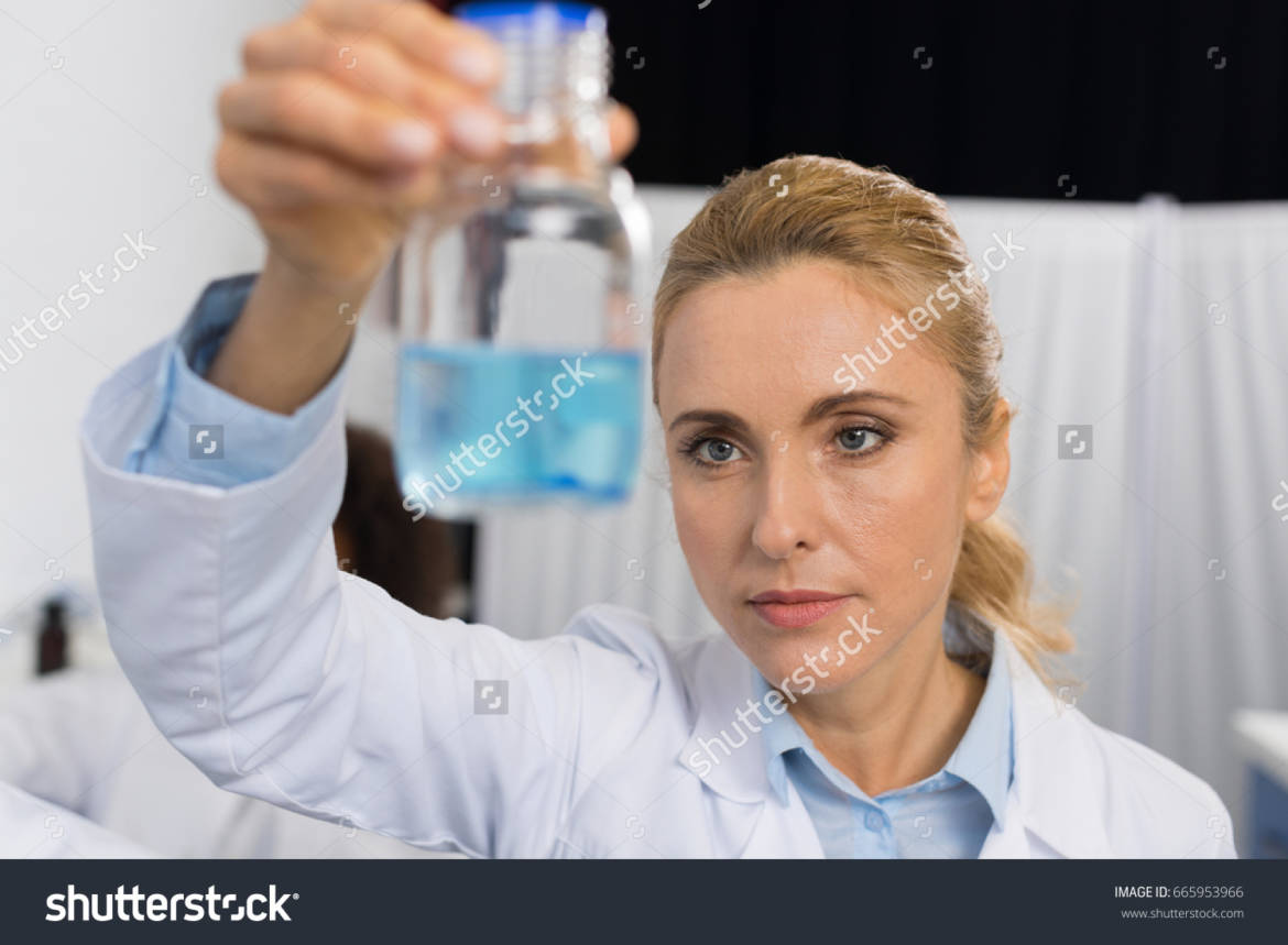 stock-photo-female-scientist-examine-flask-with-blue-liquid-working-in-modern-laboratory-attractive-woman-665953966.jpg