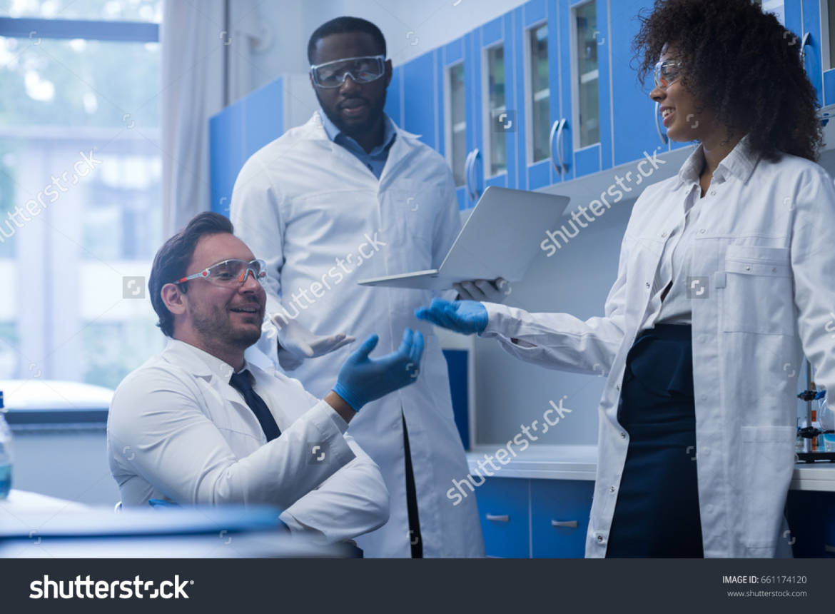 stock-photo-mix-race-scientists-team-working-in-laboratory-doing-research-man-and-woman-making-scientific-661174120.jpg